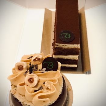 Bouchėe Confections - (Foreground) Hazelnut Praline Cake, (Background) Tiramisu - Chocolatiers & Shops Near Me - Reno, Nevada
