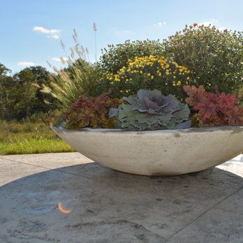 Alfresco Landscapes - Cast stone zen planters filled with fall blooming perennials. #LandCrafted - Landscaping Near Me - Grand Rapids, Michigan Alfresco Landscapes - Cast stone zen planters filled with fall blooming perennials. #LandCrafted - Landscaping Near Me - Grand Rapids, Michigan
