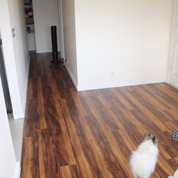 Shaka Construction - Our finished living room.  New flooring, baseboard, and fresh paint! - General Contractors Near Me