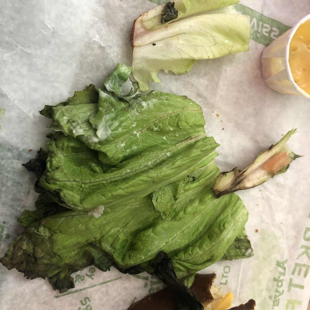 Arby's - Blackened lettuce from 2nd half of sandwich and pieces of blackened lettuce left over after already eating my 1st half - Fast Food Near Me - Mankato, Minnesota