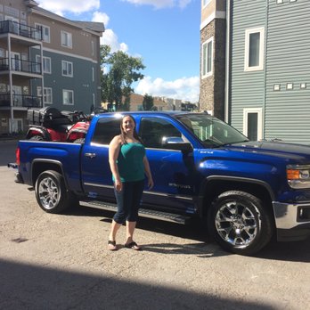 Mow Town Edmonton - a woman standing in front of a blue truck - Lawn Services Near Me - Edmonton, Alberta Mow Town Edmonton - a woman standing in front of a blue truck - Lawn Services Near Me - Edmonton, Alberta