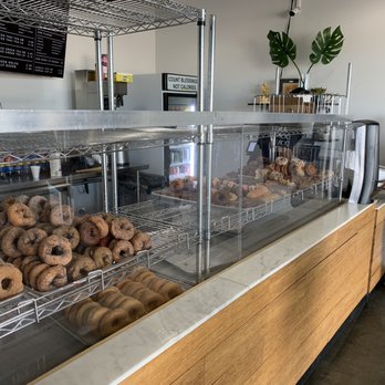 Donut Parlor - a man standing in front of a counter full of donuts - Donuts Near Me - Tempe, Arizona Donut Parlor - a man standing in front of a counter full of donuts - Donuts Near Me - Tempe, Arizona