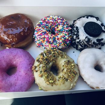 Devi's Donuts and Sweets - L-R, Creme brûlée; rainbow sprinkle; Oreo Lavender rose; pistachio lemon; plain glazed - Donuts Near Me - Long Beach, California