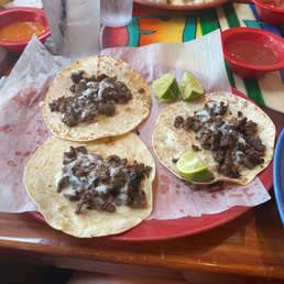 three tacos on a red plate three tacos on a red plate