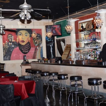 Cafe 4212 - a bar with red tablecloths and black stools - Jazz & Blues Near Me - Houston, Texas