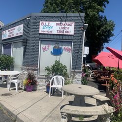 BLT Cafe St James - Some outdoor seating out front and on the right side with red umbrellas