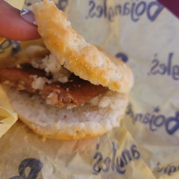 Bojangles - a hand holding a half eaten sandwich - Fast Food Near Me - Richmond, Virginia