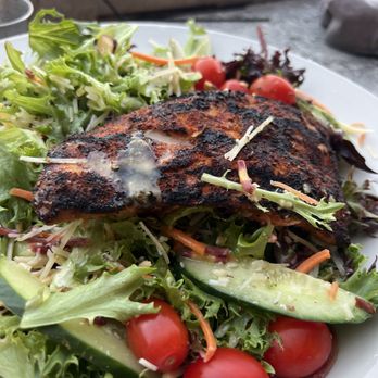 The Bridge Tender - Salmon over greens. - Seafood Near Me - Wilmington, North Carolina The Bridge Tender - Salmon over greens. - Seafood Near Me - Wilmington, North Carolina