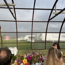 All Dahlia'd Up Flower Farm - Actual sightline from our table: tractor trailers, a giant pink pig. Floral photography displayed at eye level would have elevated the view.