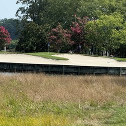 Workers standing next to the green waiting for us to hit it over their heads to the pin.
