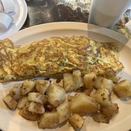 Overcooked omelet w/ side of undercooked greased potatoes Overcooked omelet w/ side of undercooked greased potatoes