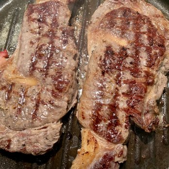 Johns Butcher Shoppe - Rib eyes cooking in the hot pan - Meat Shops Near Me - Overland, Missouri