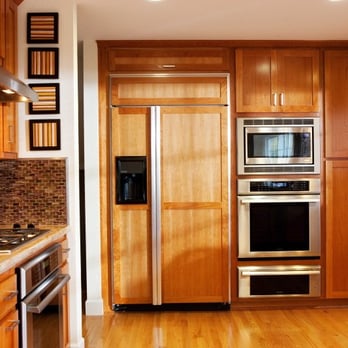 HRI Construction - a kitchen with wood cabinets and stainless steel appliances - General Contractors Near Me HRI Construction - a kitchen with wood cabinets and stainless steel appliances - General Contractors Near Me