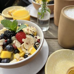 Quinoa with fruit, coconut milk latte, fresh orange juice