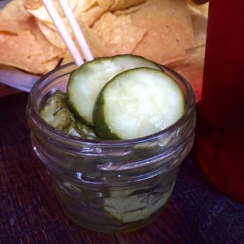 The Eagle OTR - Order of dill pickle appetizer with kale/artichoke dip chips in the background - American Near Me - Cincinnati, Ohio The Eagle OTR - Order of dill pickle appetizer with kale/artichoke dip chips in the background - American Near Me - Cincinnati, Ohio