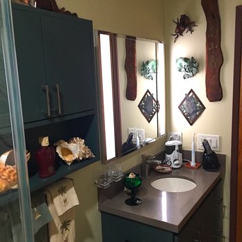 LB Construction & Remodeling - This was taken from inside the walk-in frameless shower showing the vanity/sink, cabinet over the toilet and wall art - General Contractors Near Me - Foster City, California