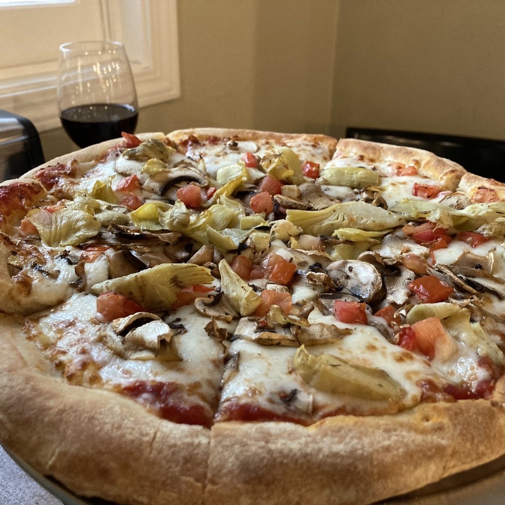 Timberloft Pizzeria - 12 slice pizza with tomato, mushroom, and artichoke - Pizza Near Me - Fish Camp, California Timberloft Pizzeria - 12 slice pizza with tomato, mushroom, and artichoke - Pizza Near Me - Fish Camp, California