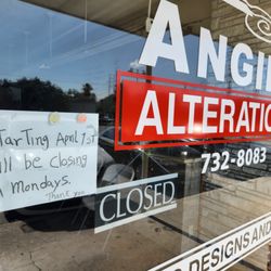 Angie's Alterations - Sign showing business is closed on Mondays despite posted hours on storefront and Google