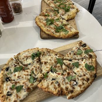 Vegan Cave Cafe - Vegan tandoori pizza on top and vegan walnut pizza on bottom. So freaking delicious!! And filling. - Pizza Near Me - Vancouver, British Columbia
