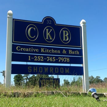 Creative Kitchen and Bath - a blue sign in the grass - General Contractors Near Me - Merritt, North Carolina