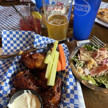 Cousins Pub - Hot honey wings and side house salad. Wings were huge and meaty. Full size pint glass for sizing. - Sports Bars Near Me - Bozeman, Montana