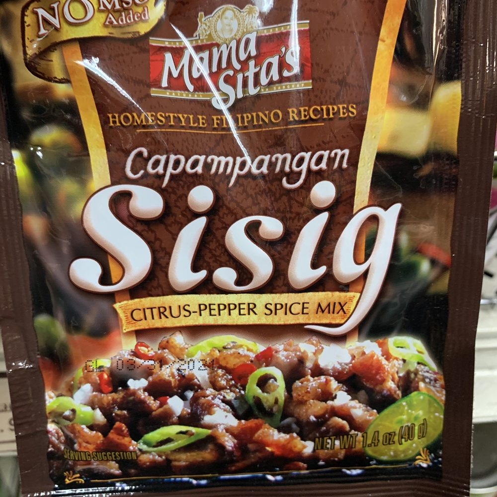 Asian Market - a hand holding a bag of chili pepper spice mix - Grocery Near Me - Provo, Utah