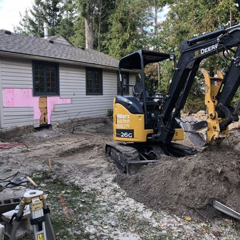 S Hughes Home Improvements - a small excavator digging a hole - Carpenters Near Me S Hughes Home Improvements - a small excavator digging a hole - Carpenters Near Me