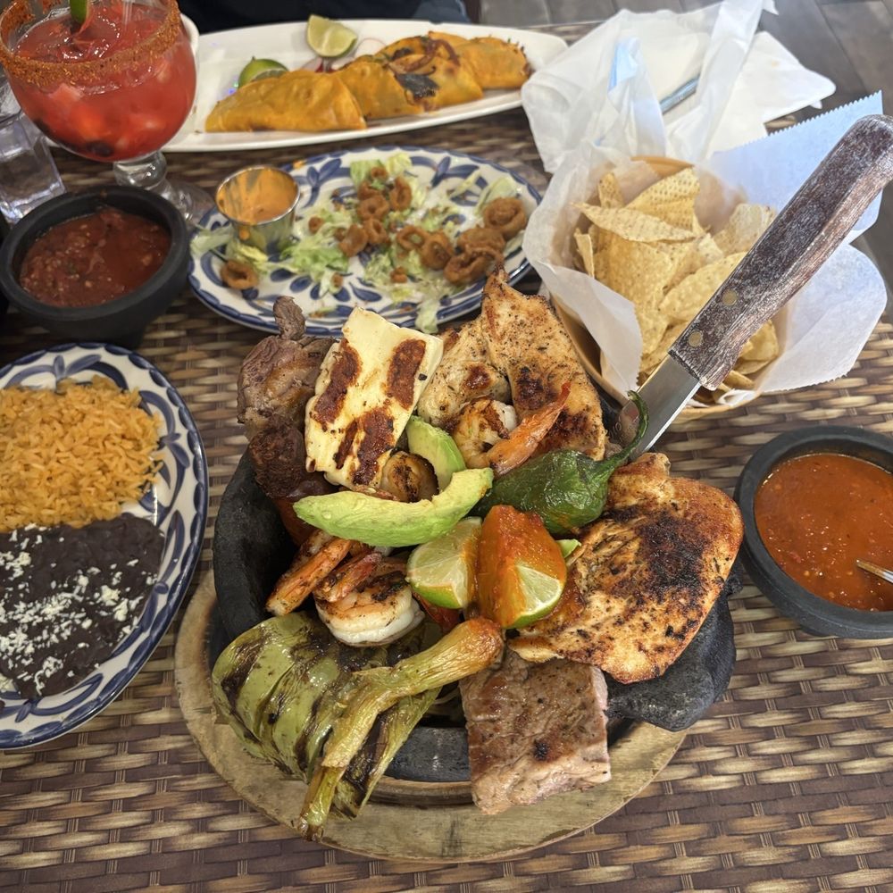 Mi Lindo Cancun Grill - Molcajete Mar y Tierra, picante, refried beans and rice, fried calamari , chips and house made salsa, and birria tacos - Mexican Near Me - Annapolis, Maryland