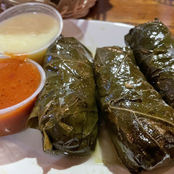 Pegasus Taverna - Warm grape leaves appetizer with their tomato sauce and lemon sauce on the side: - Greek Near Me - Detroit, Michigan Pegasus Taverna - Warm grape leaves appetizer with their tomato sauce and lemon sauce on the side: - Greek Near Me - Detroit, Michigan