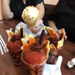 a woman holding a cup of ice cream a woman holding a cup of ice cream