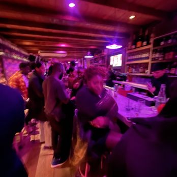 El Coco - a group of people sitting at a bar - Tacos Near Me - New York, New York