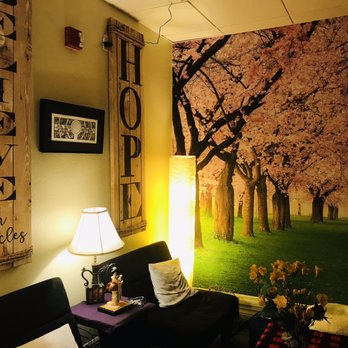 Elixir Tea House - a living room with a couch and a lamp - Coffee & Tea Near Me - Sarasota, Florida