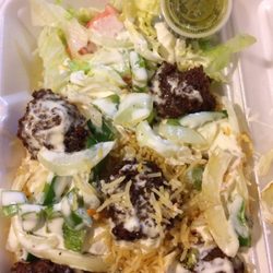 Taha's Halal Grill - Falafel over rice with pepper, onions, salad and white sauce with green hot sauce on the side. Huge portion!