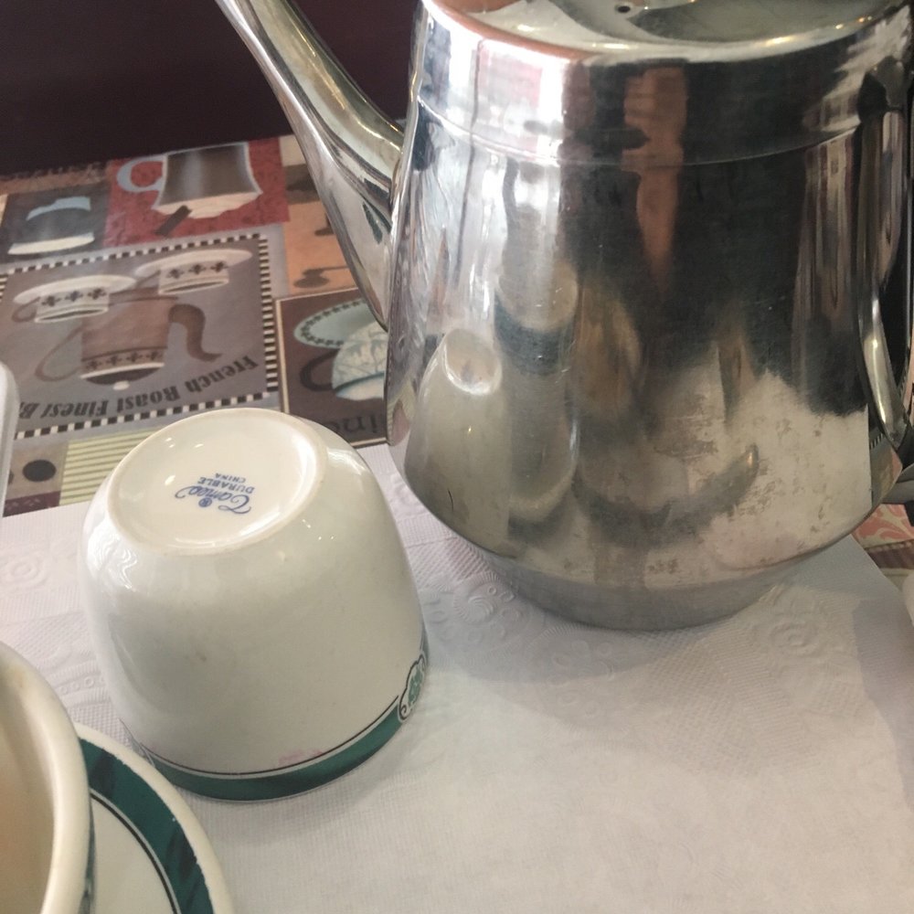 a tea pot and a cup of tea a tea pot and a cup of tea