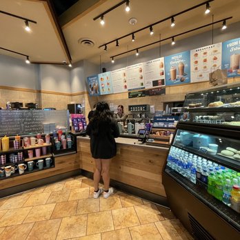 Caribou Coffee - a woman standing in a coffee shop - Coffee & Tea Near Me - Bloomington, Minnesota