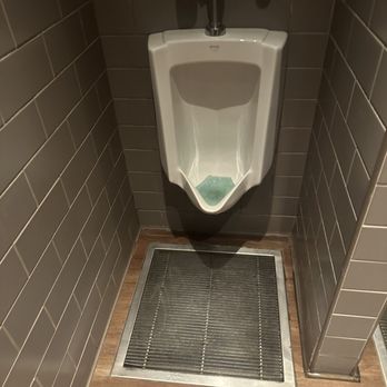 Seasons 52 - Restrooms with clean urinal and a drain in floor!  Smart! - Seafood Near Me - Buford, Georgia