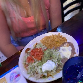 Los Rancheros - a woman sitting at a table with a plate of food - Mexican Near Me - Santa Rosa Beach, Florida Los Rancheros - a woman sitting at a table with a plate of food - Mexican Near Me - Santa Rosa Beach, Florida