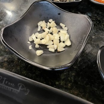 Iron Pig - Chopped garlic...sliced garlic would've been better for the grill. - Barbeque Near Me - Berwyn Heights, Maryland