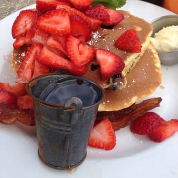 Cody's La Jolla - Blueberry pancakes. Topped with strawberries - Breakfast & Brunch Near Me - La Jolla, California Cody's La Jolla - Blueberry pancakes. Topped with strawberries - Breakfast & Brunch Near Me - La Jolla, California