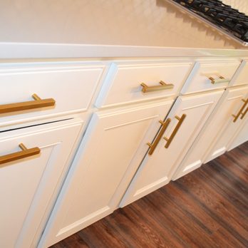 MJ Brown Renovations - a kitchen with white cabinets and brass pulls - Interior Design Near Me - Carmel, Indiana MJ Brown Renovations - a kitchen with white cabinets and brass pulls - Interior Design Near Me - Carmel, Indiana