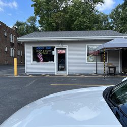 About Time & American Passport - Storefront with a few parking spaces
