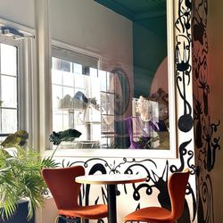 Cara's Cat Cafe - Look how cute the paintings on the wall are! And you can see the cat room from the cafe side!