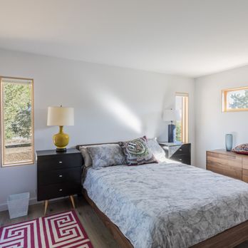 Holly Construction - a bedroom with a bed, dresser, and window - General Contractors Near Me - Santa Rosa, California Holly Construction - a bedroom with a bed, dresser, and window - General Contractors Near Me - Santa Rosa, California