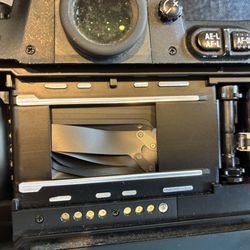 Steve's Camera Service Center - back of F 100 camera. Can it be fixed?  How much?310-367-8353