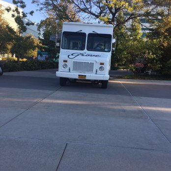 The Grove Juice Truck - a white bus parked in a parking lot - Food Trucks Near Me The Grove Juice Truck - a white bus parked in a parking lot - Food Trucks Near Me