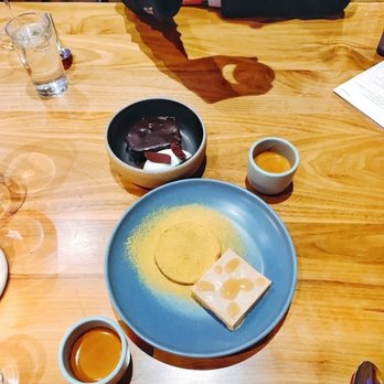 Elske - (top) Fried bread with dark chocolate sauce and bay leaf (bottom) Sunflower seed parfait with sour honey, licorice, and bee pollen - Scandinavian Near Me - Chicago, Illinois