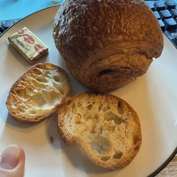 La Parisienne French Bakery - Chocolate croissant and some bread and butter that came with the quiche but my partner stole it lol - Cafes Near Me - Seattle, Washington La Parisienne French Bakery - Chocolate croissant and some bread and butter that came with the quiche but my partner stole it lol - Cafes Near Me - Seattle, Washington