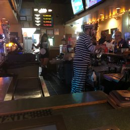 a man in a striped shirt at the bar