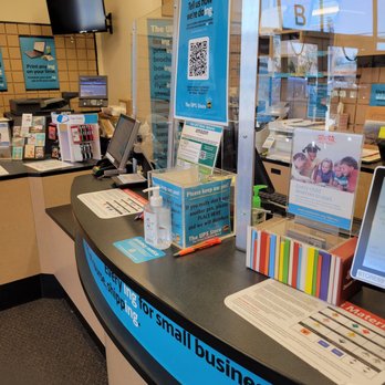 The UPS Store - The image shows the interior of a UPS Store with a curved counter, digital screens, and signage related to shipping and customer service. - Mailbox Centers Near Me - Pasadena, Maryland