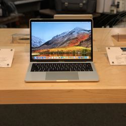 Mac-Ave - New MacBook Pro 13-inch with Touch Bar on display.